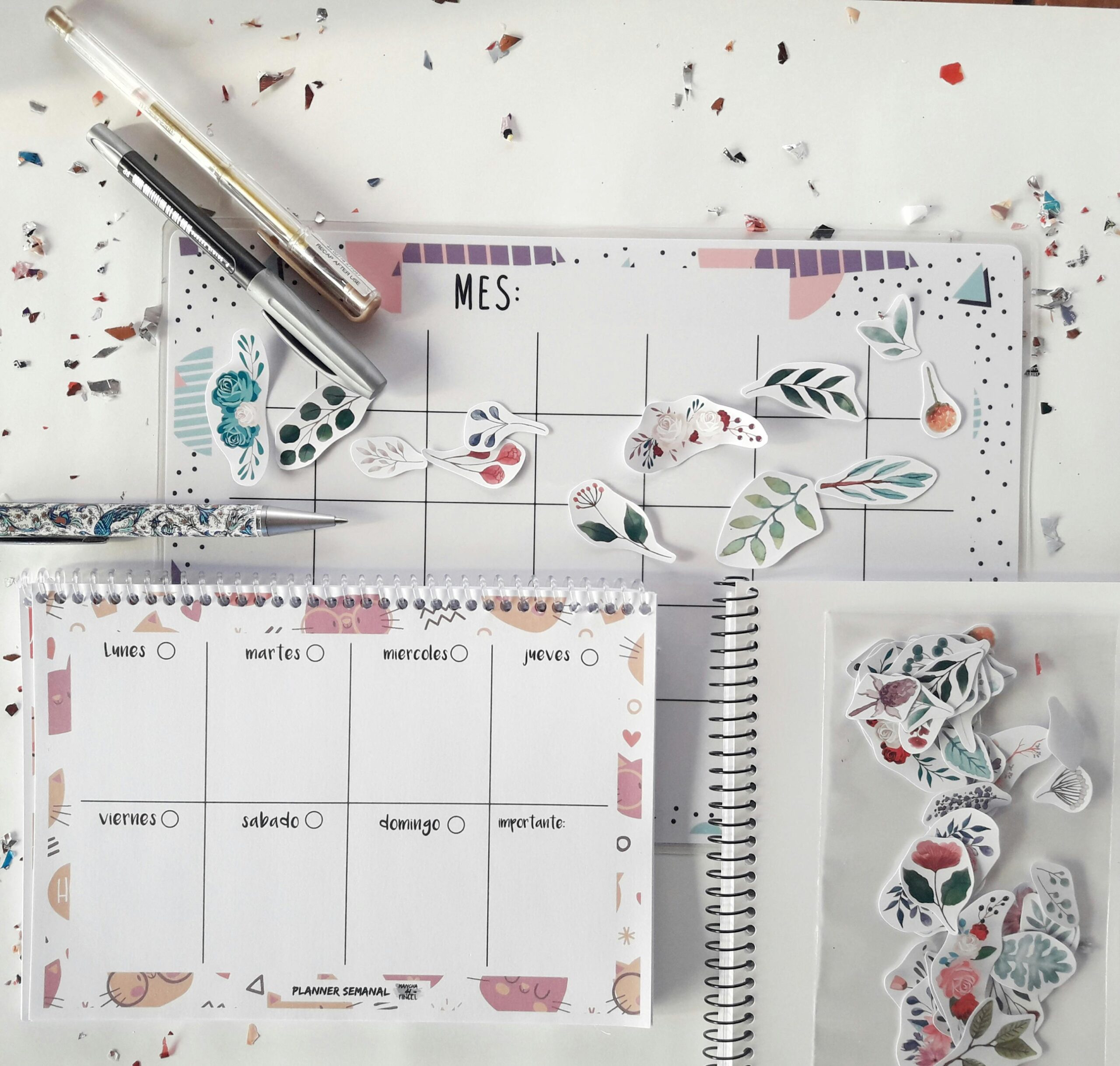 Flat lay of a planner with decorative stickers and stationery for organizing tasks creatively.